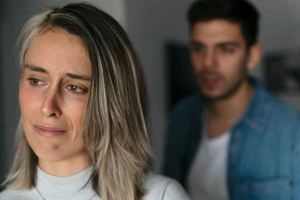 Visibly upset woman turns away from her husband after sharing news of a missing relative