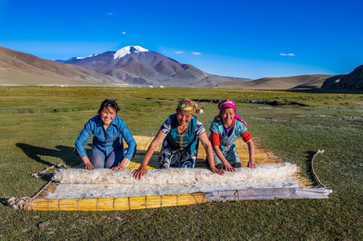 A family hand makes a felt yurt to live in on the tundra lands of Ulgii, Mongolia
