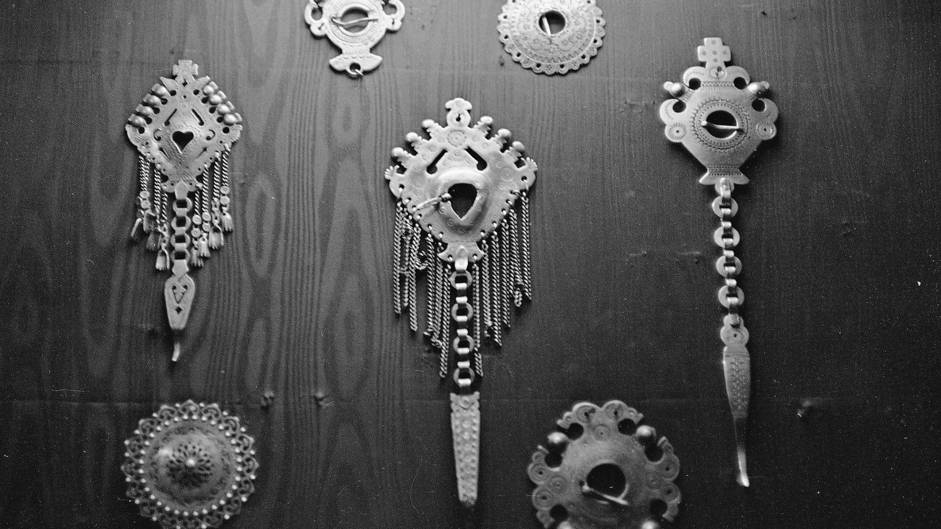 An assortment of silver brooches.