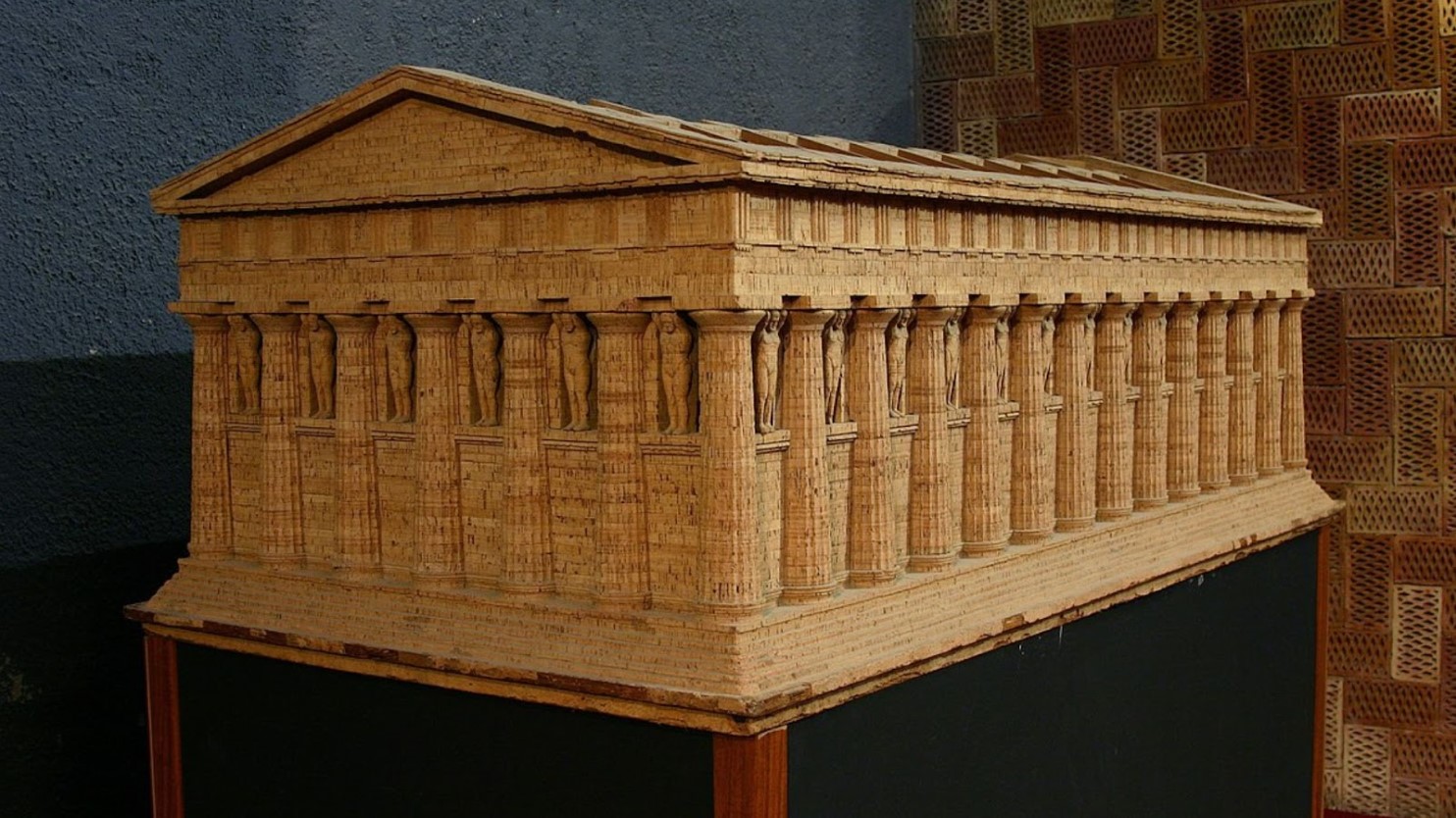 Model of an ancient Greek temple stands on a table.