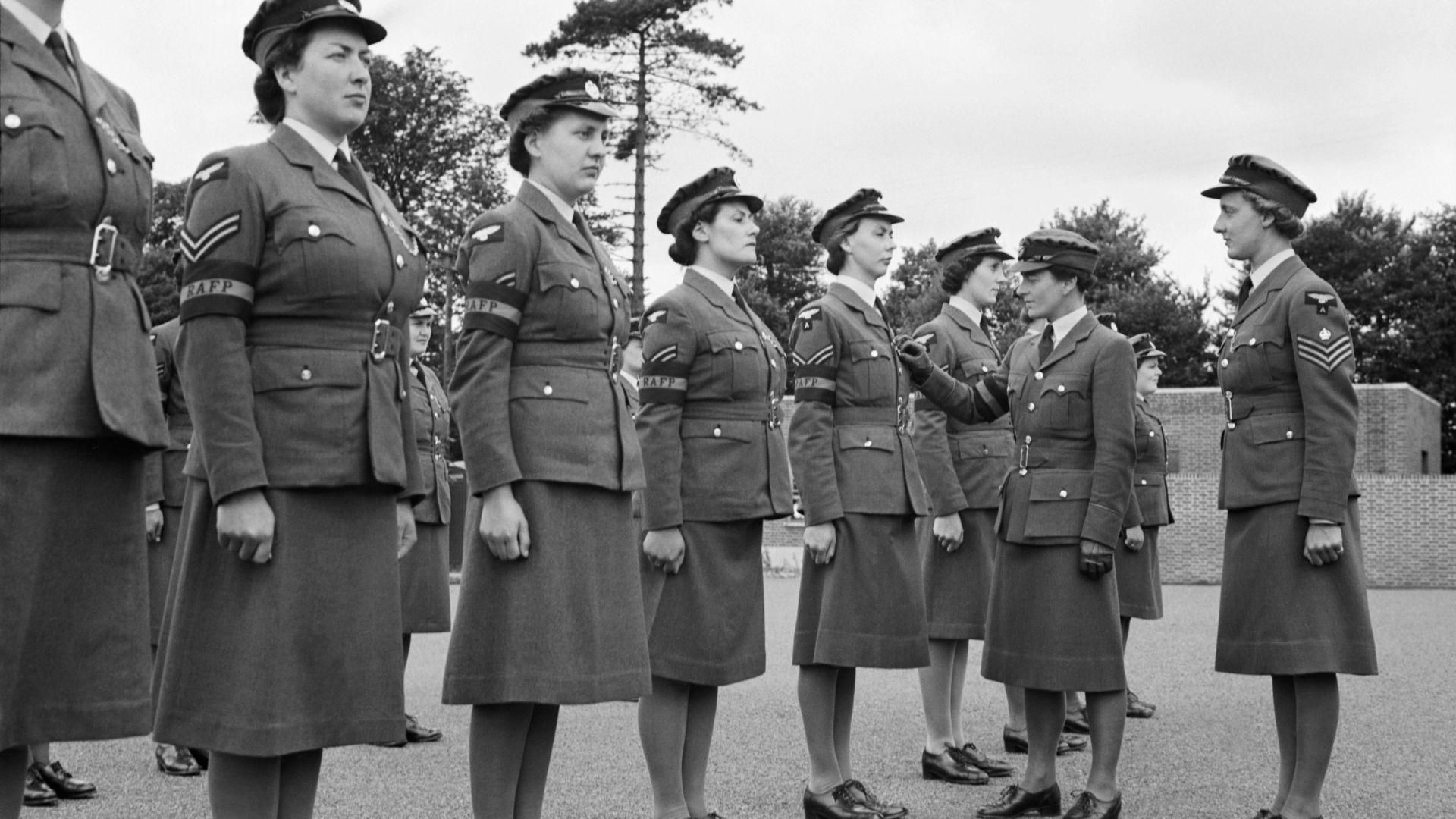 A row of Women’s Auxiliary Air Force being inspected during World War II.