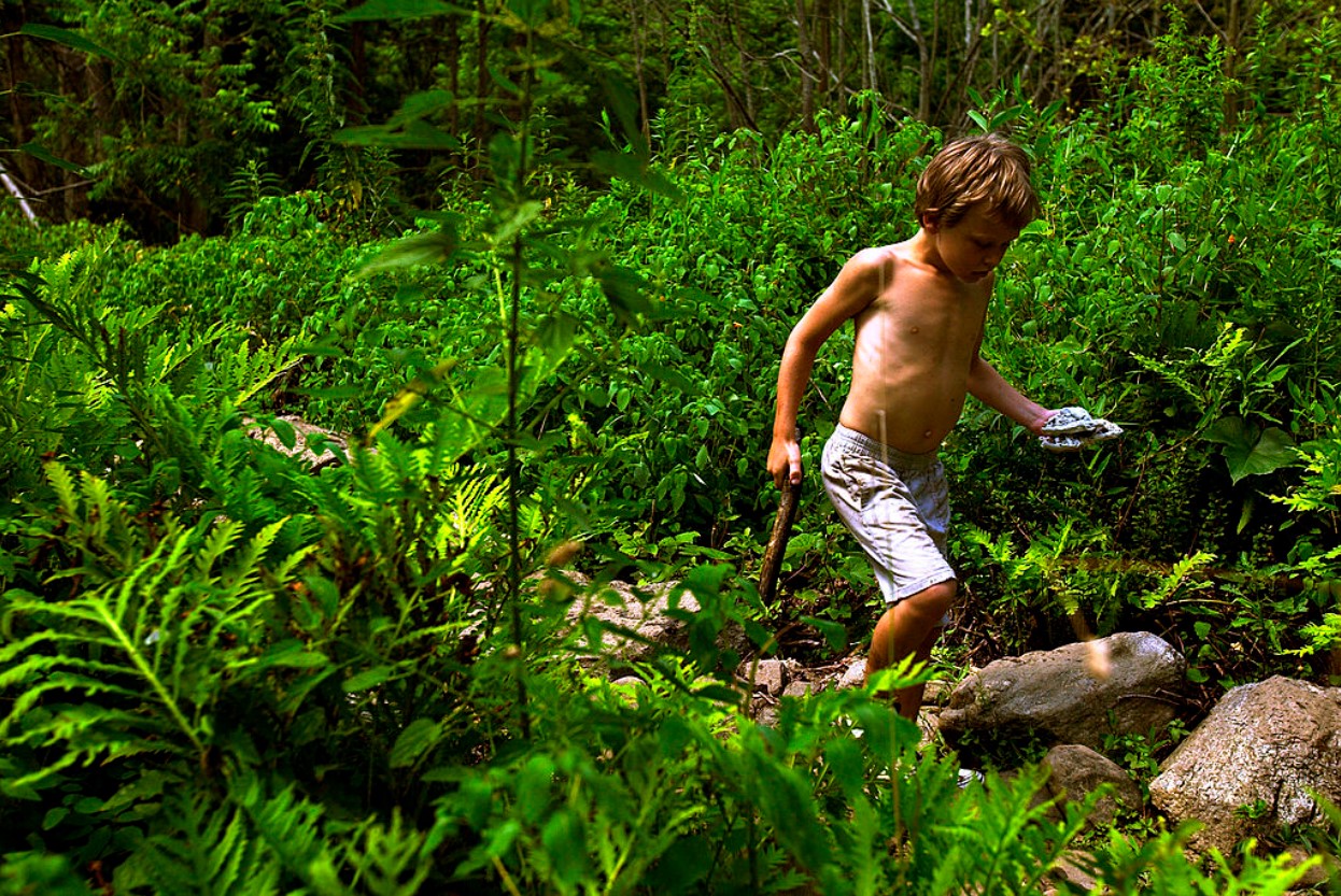 A student at the Center for Attention and Related Disorders (C.A.R.D.) camp makes his way through the forest