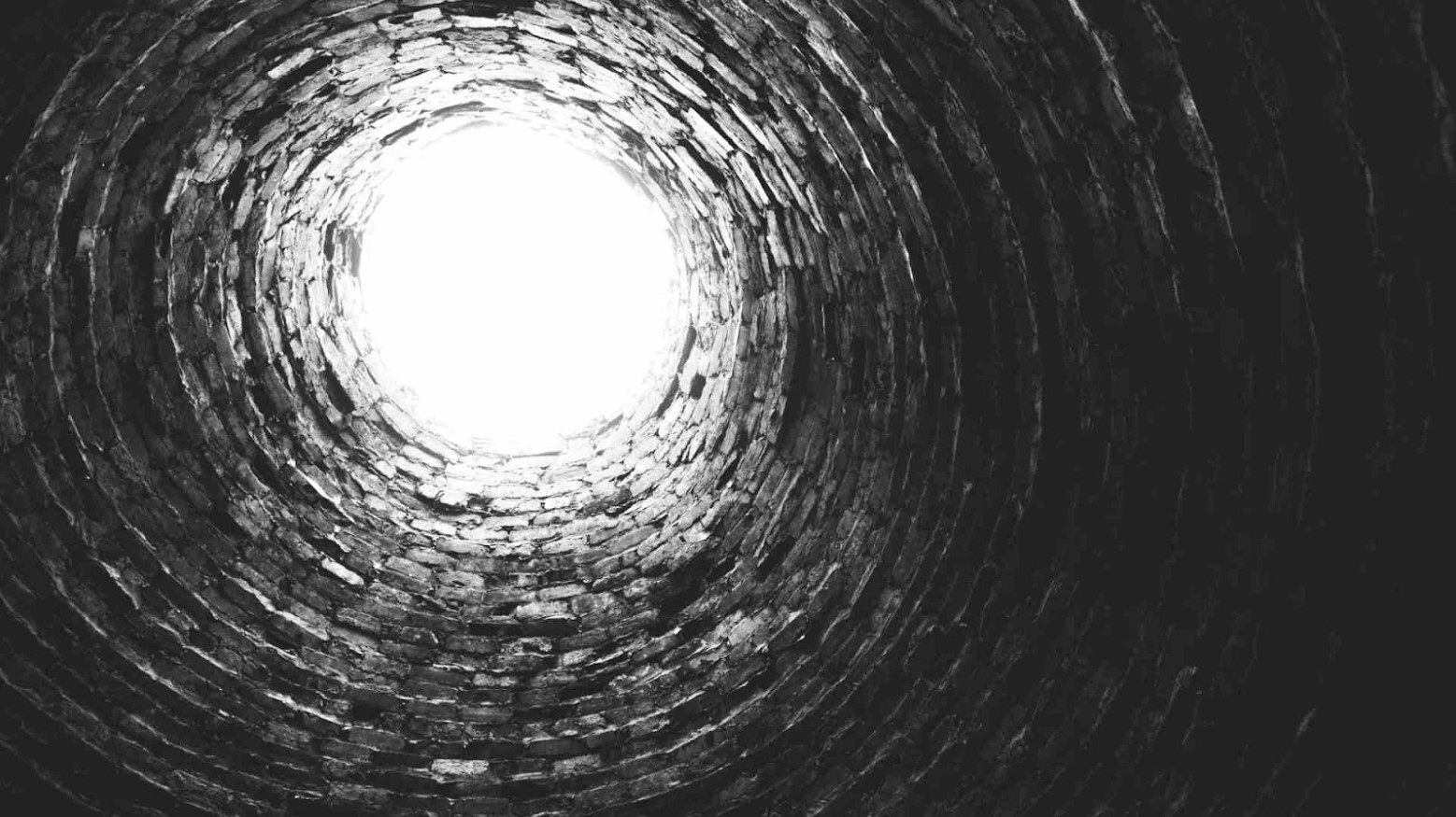 The opening of a well is seen from the bottom.