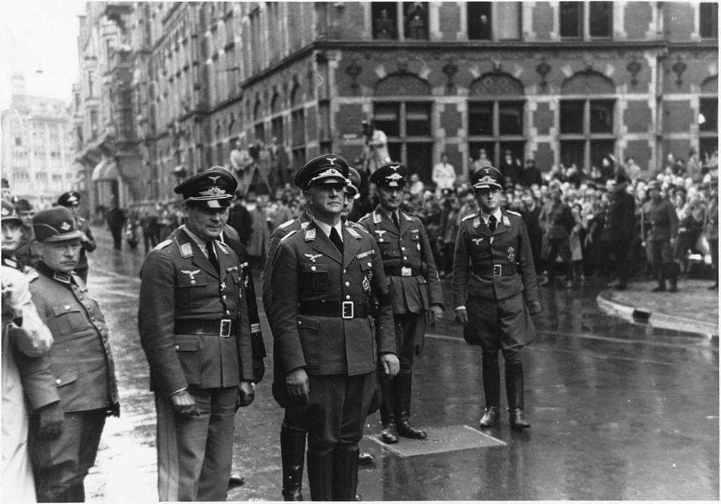 Air General Friedrich Christiansen (third from the left) arrives in The Hague at the Lange Poten street near the Plein square accompanied by a number of high ranking German officers. On the background spectators and photographers. Adolf Hitler appointed General Christiansen as Supreme Commander of the Nazi-German Armed Forces in the Netherlands. He remained at this post for the entire duration of the Second World War