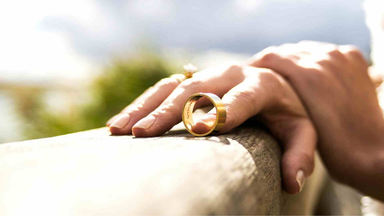 A woman taking her wedding ring off.