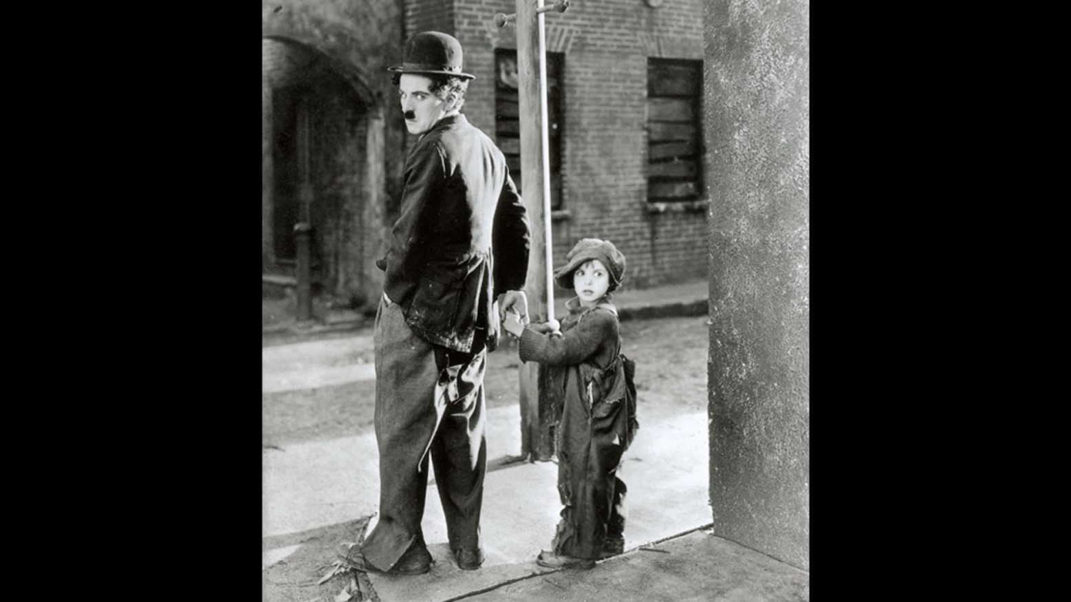 Still from the 1921 film “The Kid” with Charlie Chaplin and Jackie Coogan