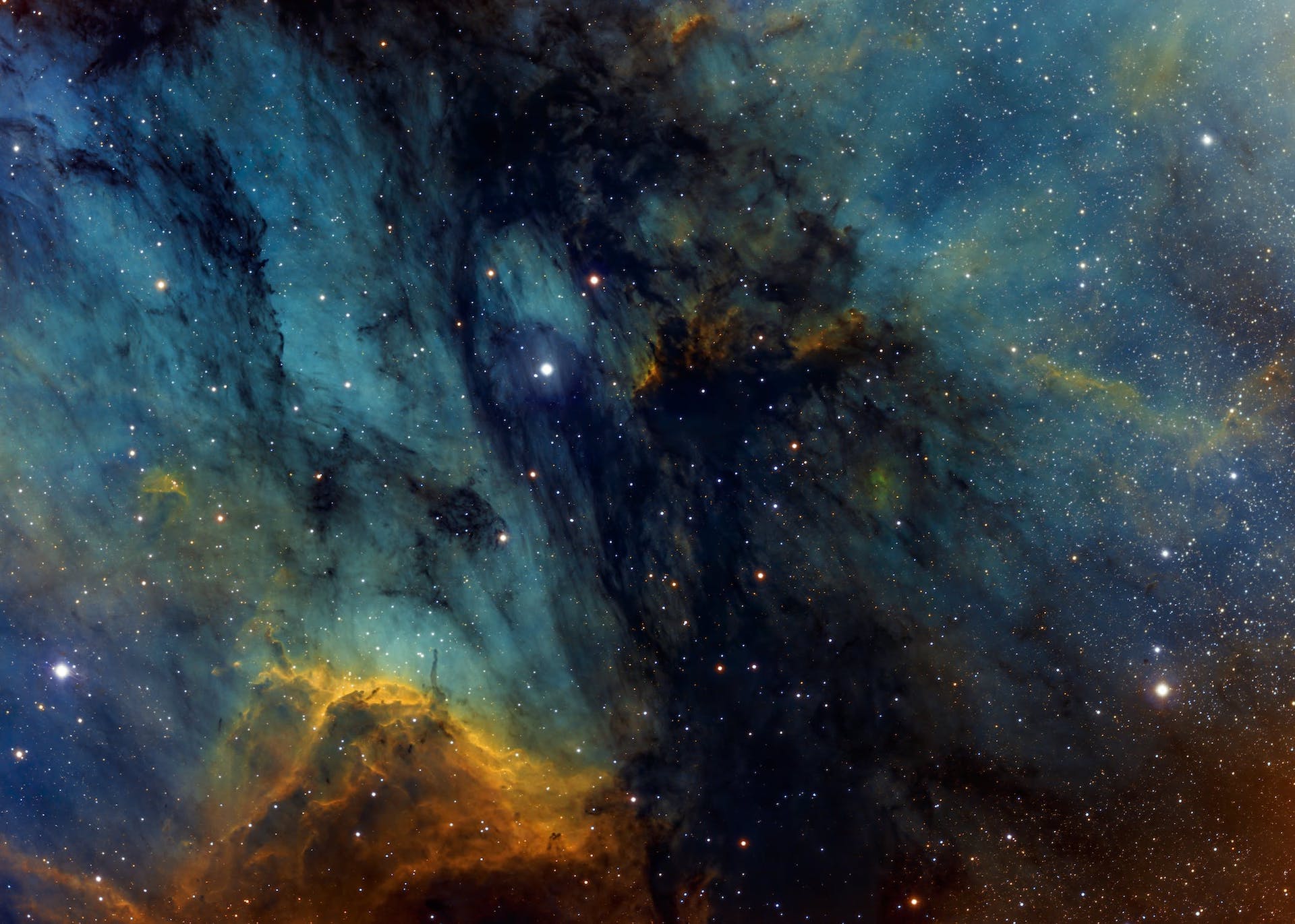 A blue and yellow swirl of a galaxy in space