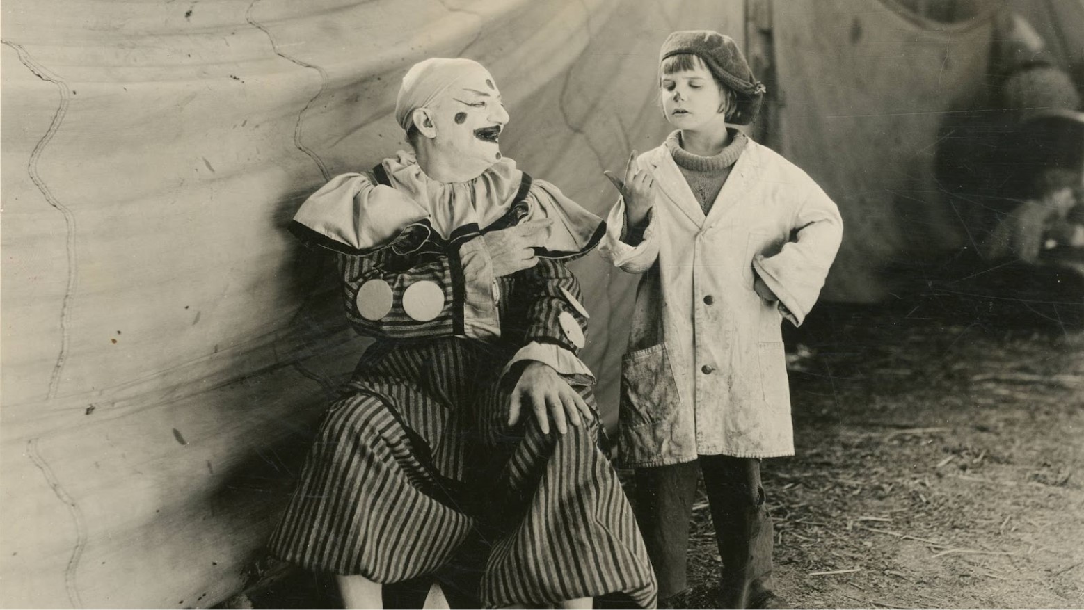 Child actor Jackie Coogan with a clown in a still from the 1923 movie “Circus Days.”