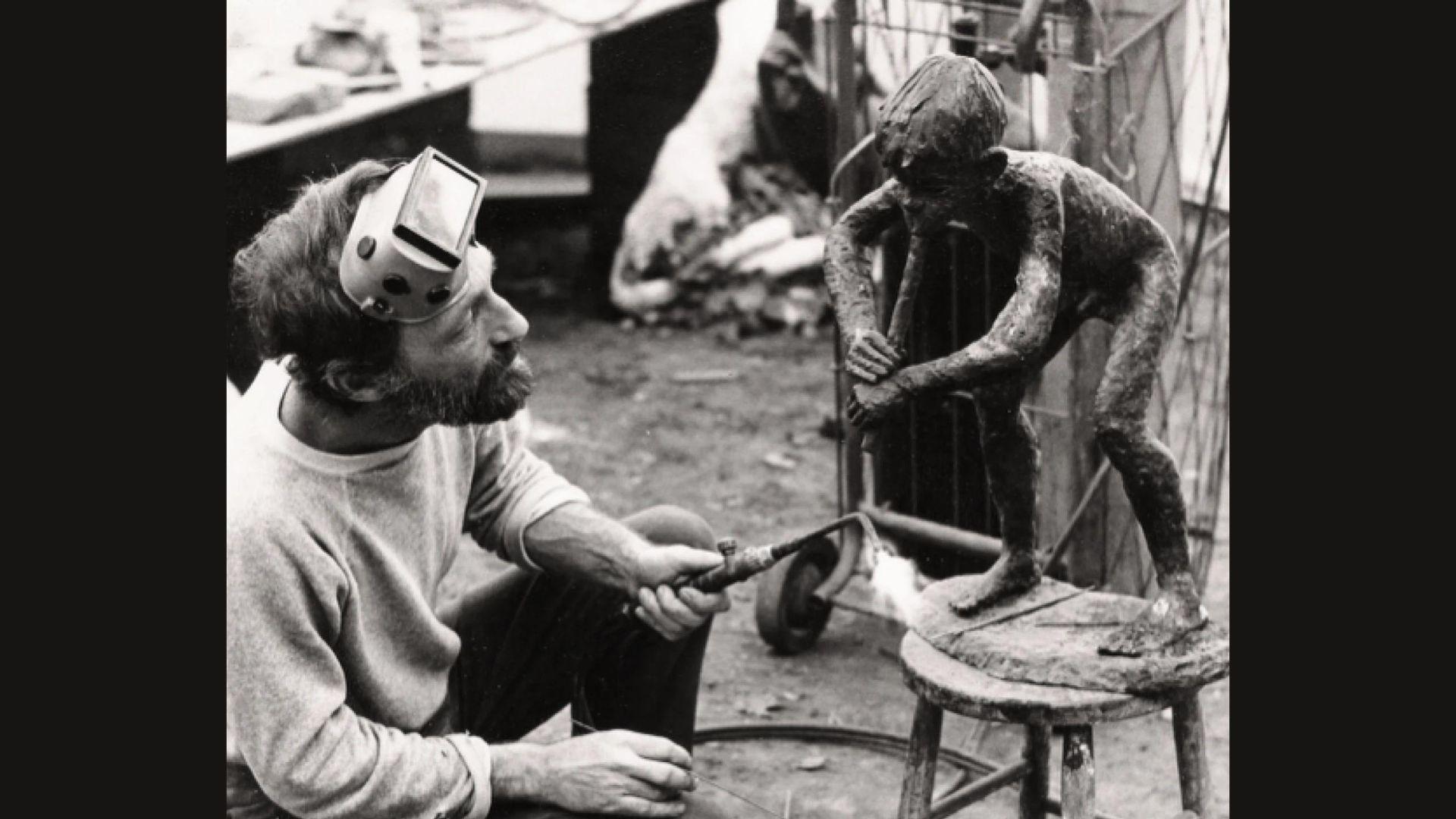 Artist working on the Pan statue in Louisville, Kentucky in black and white