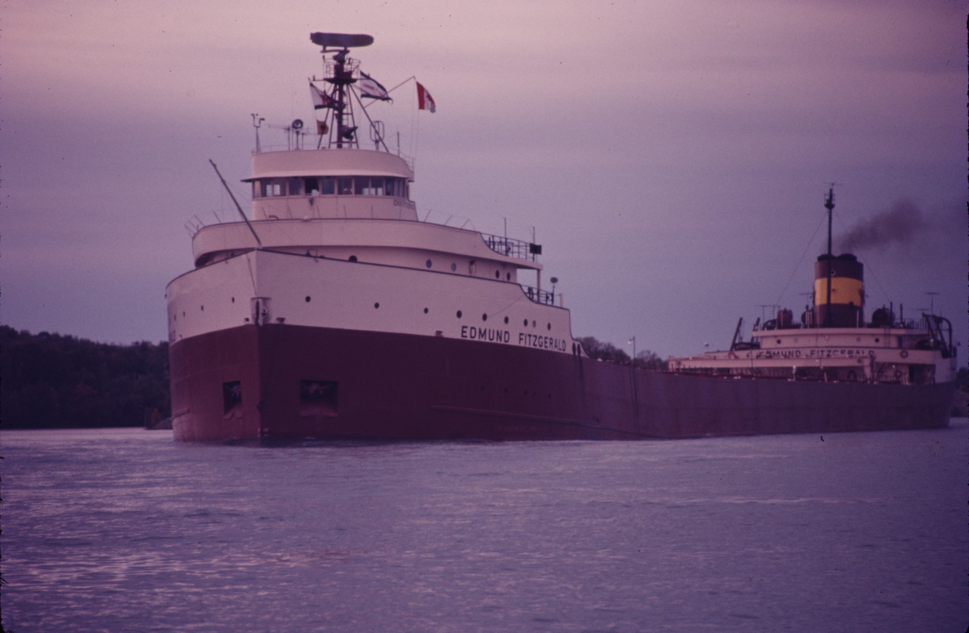 A large white and black ship in the water during the early morning hours