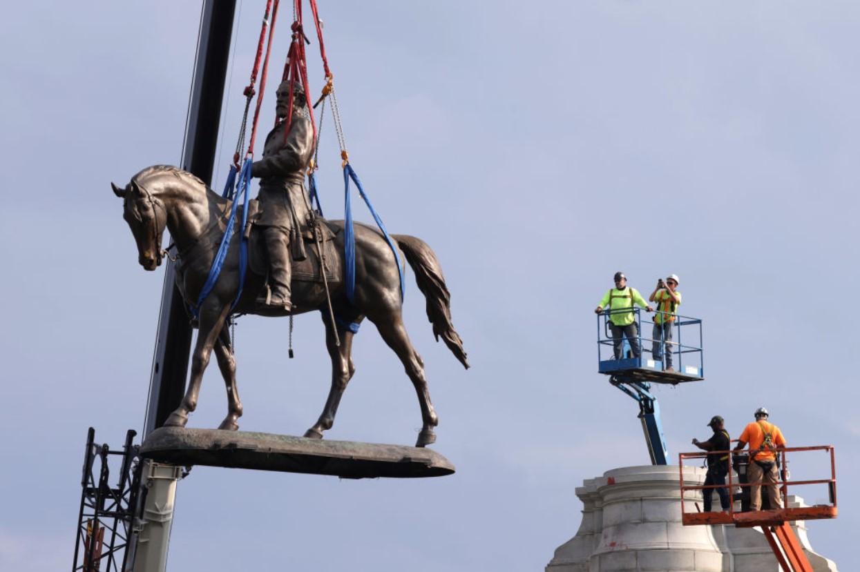 The statue of Robert E. Lee is lowered from its pedestal at Robert E. Lee Memorial during a removal on September 8, 2021, in Richmond, Virginia
