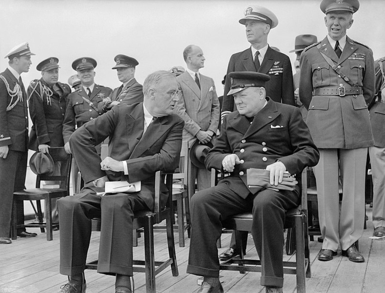 President Roosevelt and Winston Churchill seated on the quarterdeck of HMS PRINCE OF WALES for a Sunday service during the Atlantic Conference, 10 August 1941