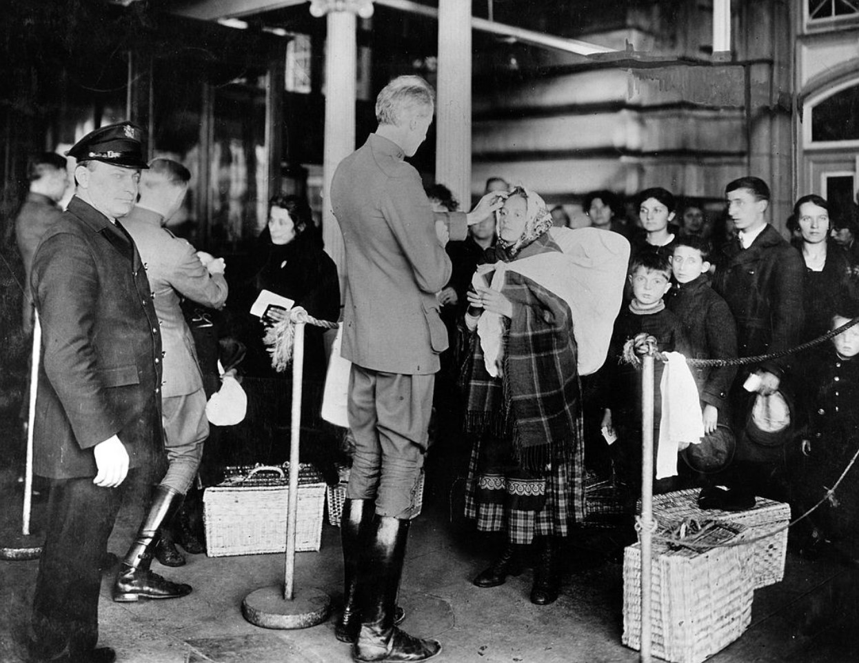 In this 1910 photo, physicians are looking at the eyes for signs of trachoma in immigrants on Ellis Island