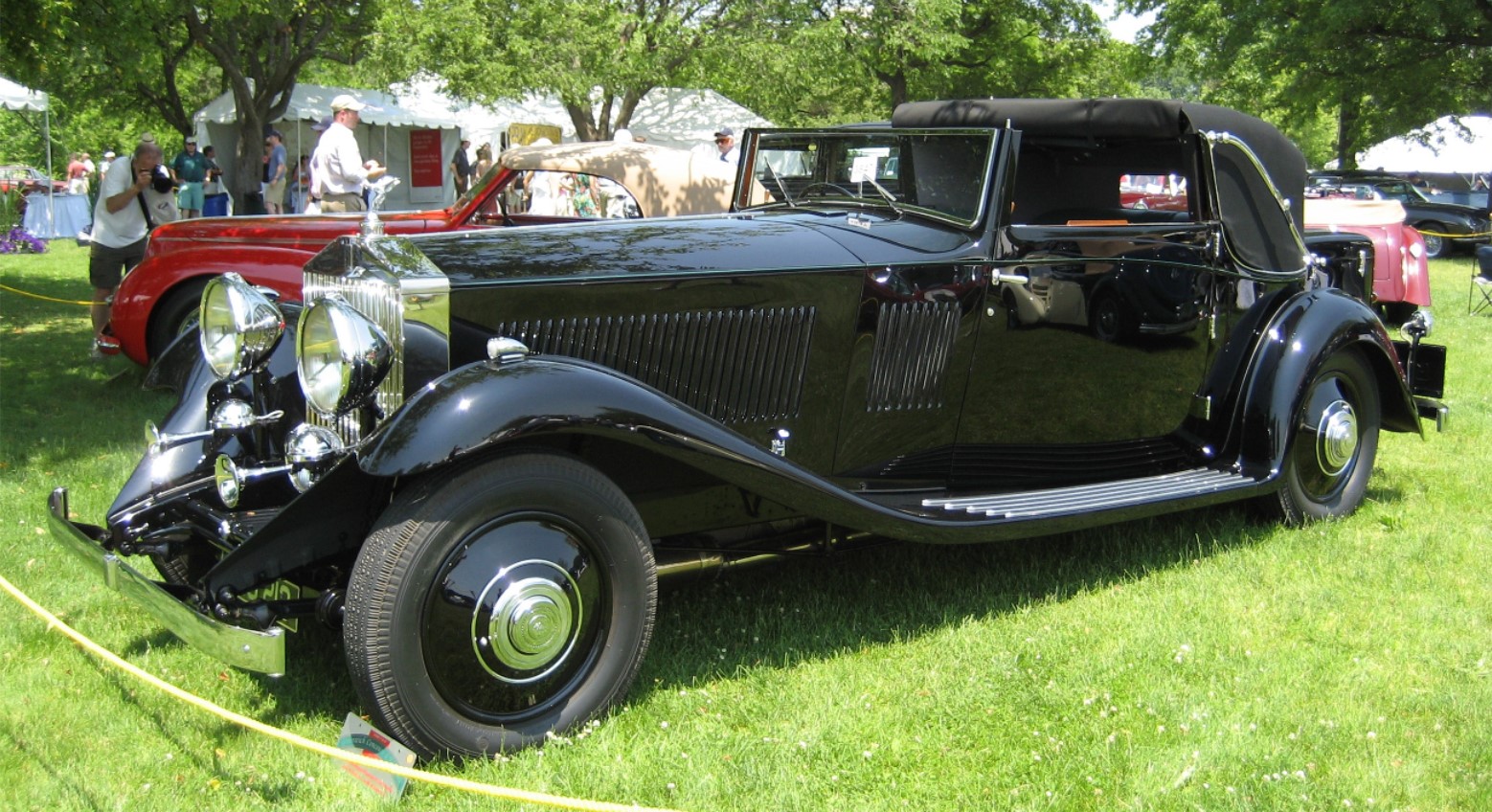 1933 black Rolls Royce on the grass at a car show