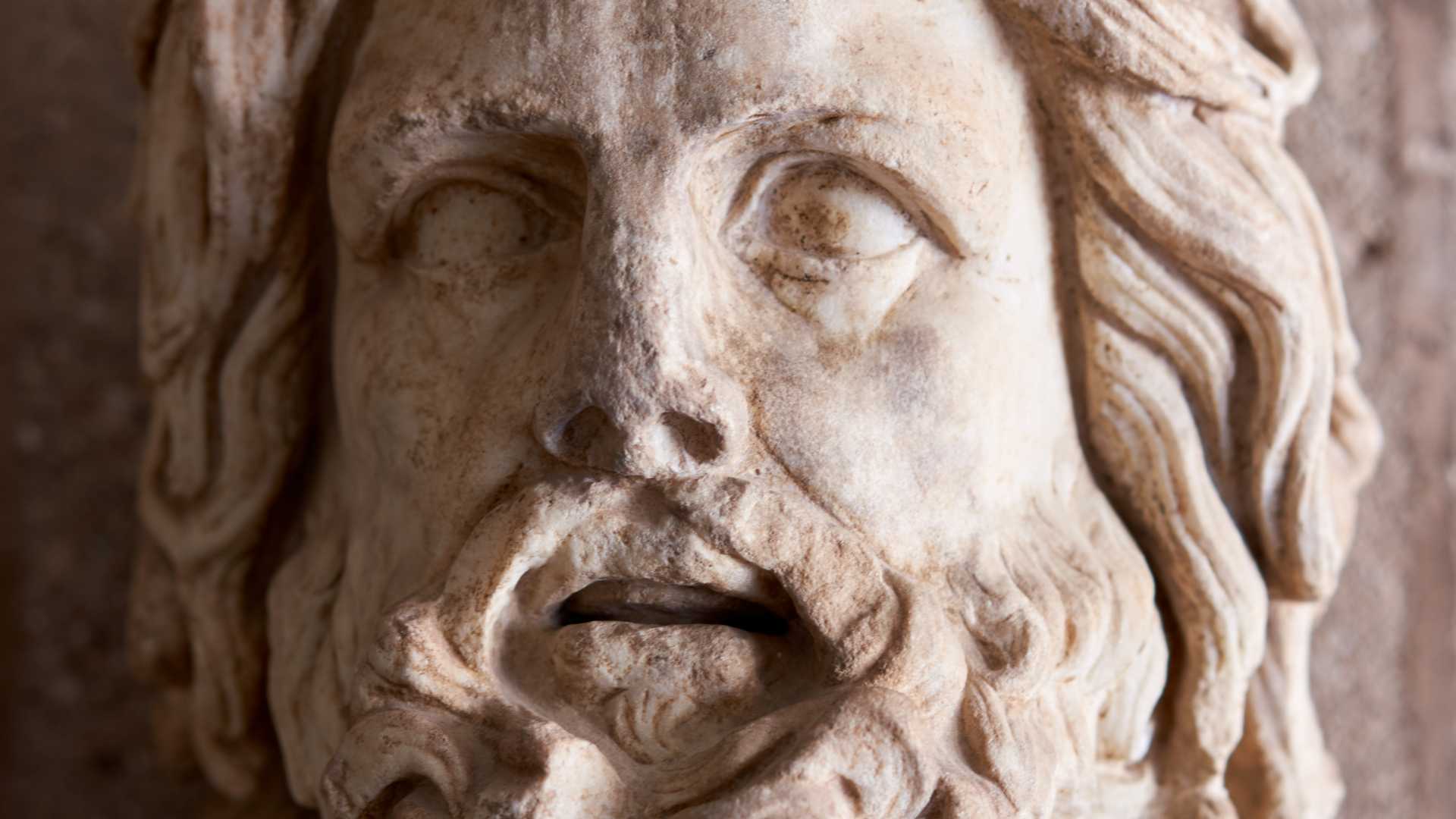 A closeup photo of a statue of Zeus.