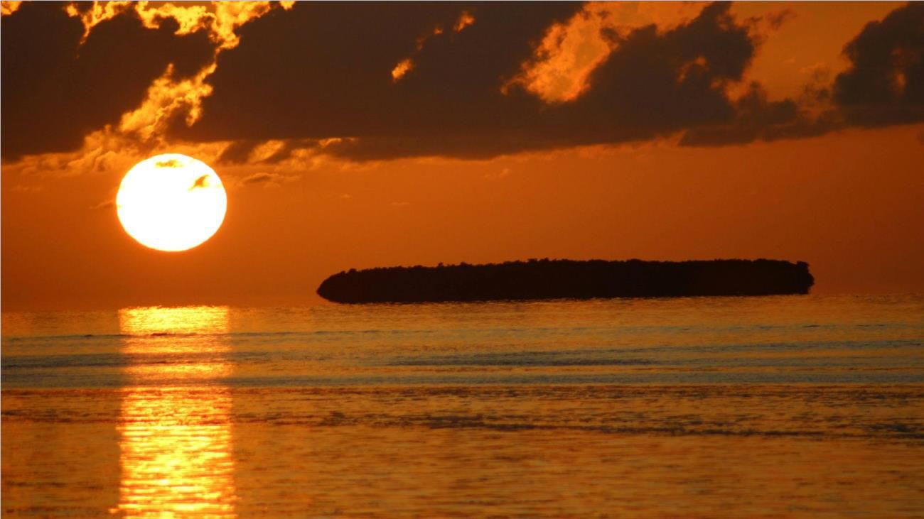 A red and orange sunset over a body of water by Key West, Florida.