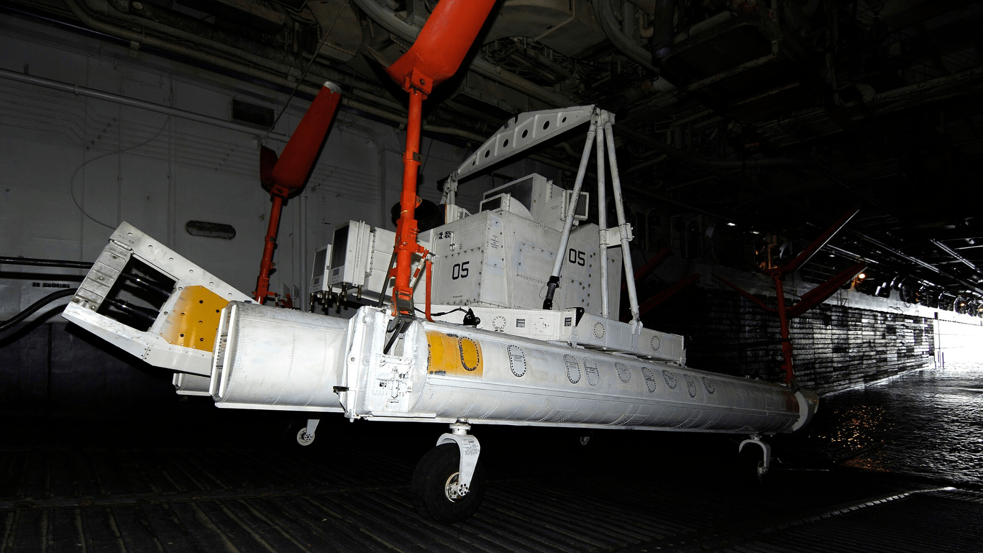 A magnetic sled is lowered into the water on a ramp.