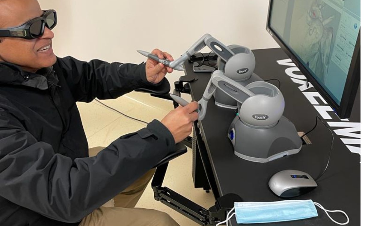 Professor Gupta is pictured playing with a simulator at a university