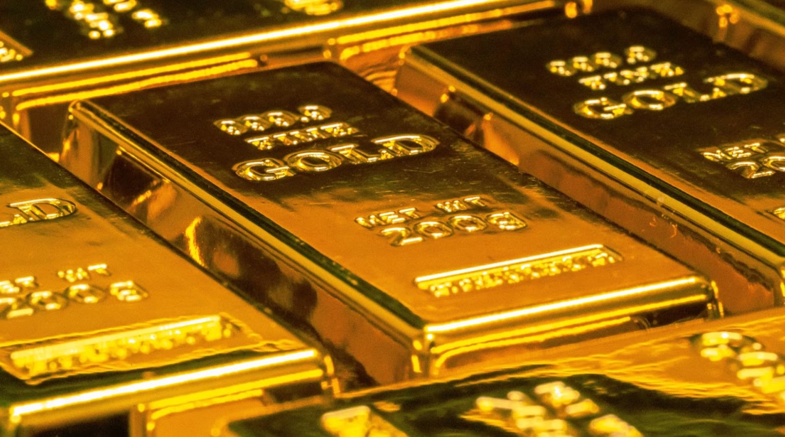 Bars of gold with imprints in them, including the word ‘gold’.