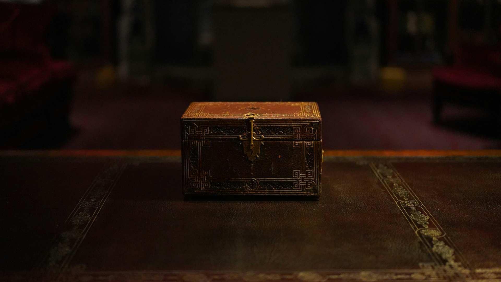 An old chest sitting on the table.