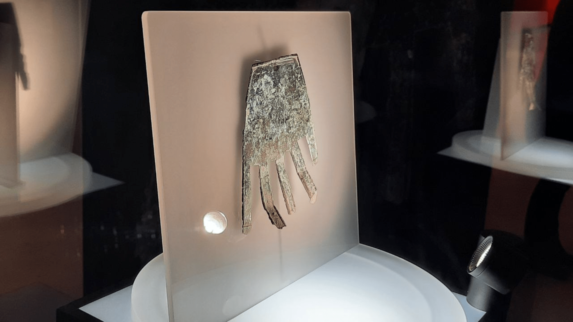 Another hand amulet from Irulegi in a display case at the planetarium of Pamplona.