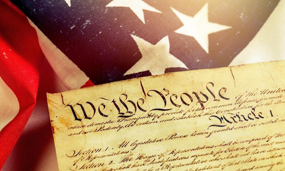 US Constitution on top of an American flag