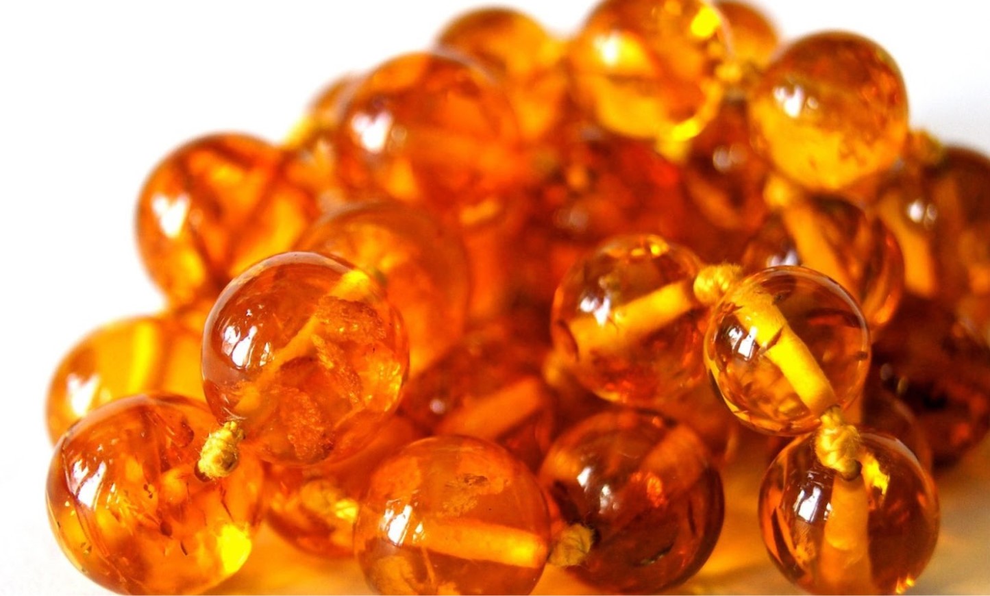 An example of some amber pearls, which are not the amber pearls that the boys found under the Church. The pearls are orange and they are all joined together by a chain.