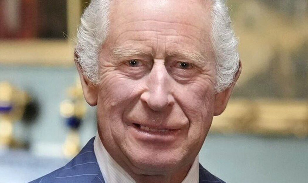 An up-close image of King Charles dressed in a pin-striped suit