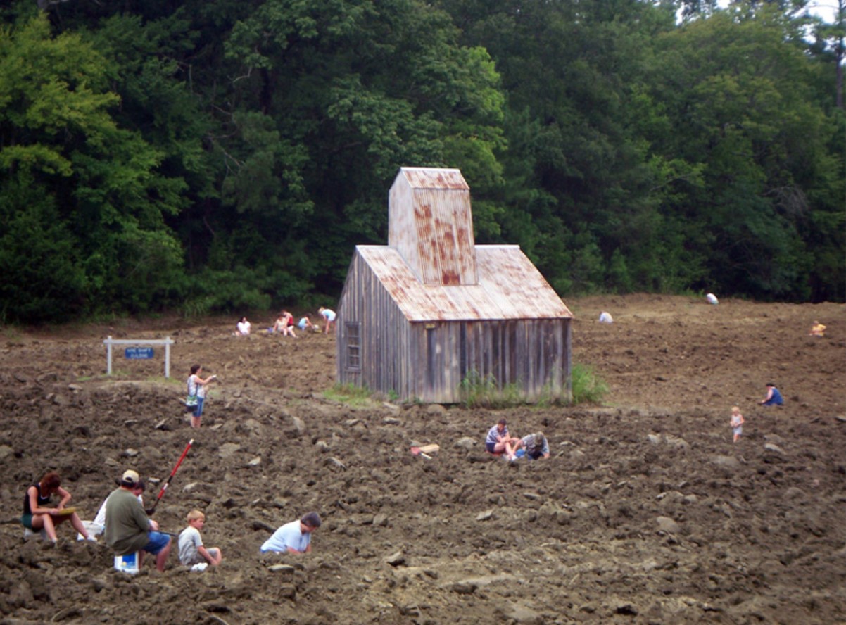 An image taken at the Crater of Diamonds park showing several people hunting for diamonds