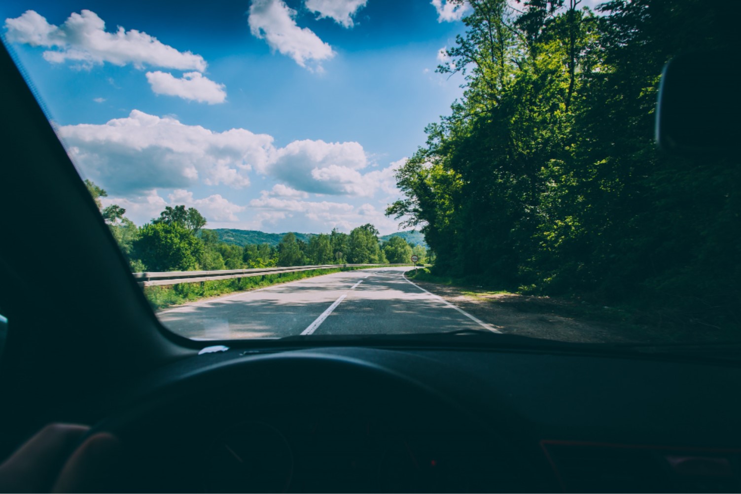 A man is pictured driving a car across the states