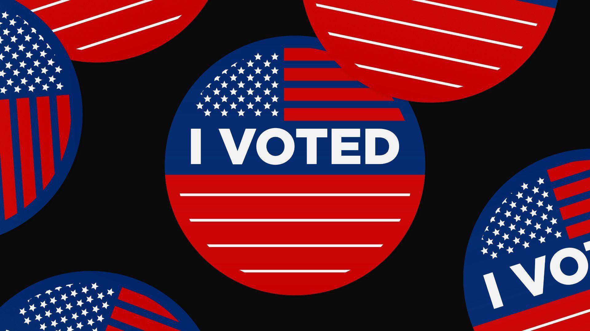 A close-up on voting stickers against a black background.