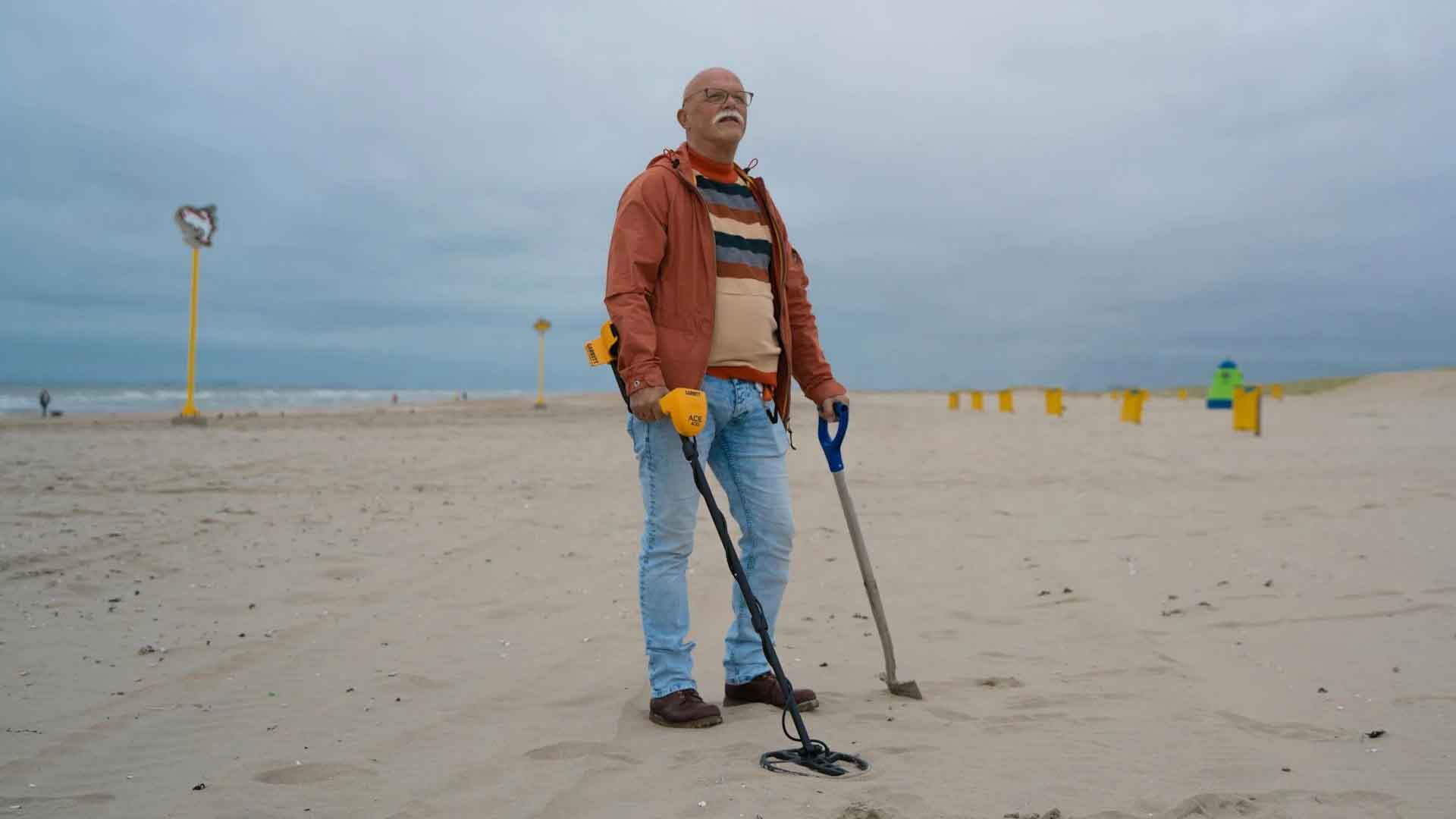 Treasure Hunter on Beach with metal detector