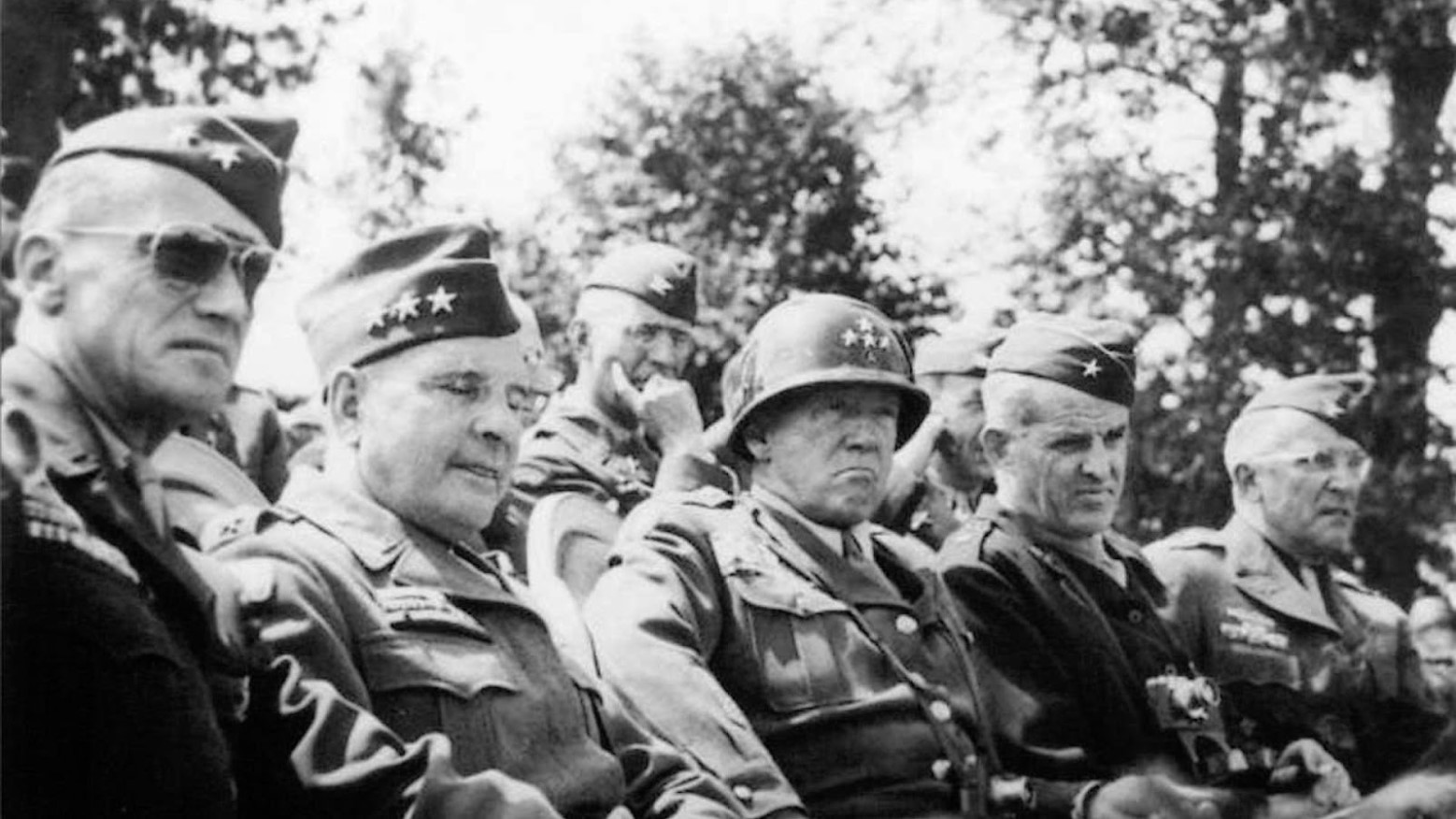 George Patton sitting alongside other military leaders during World War II.