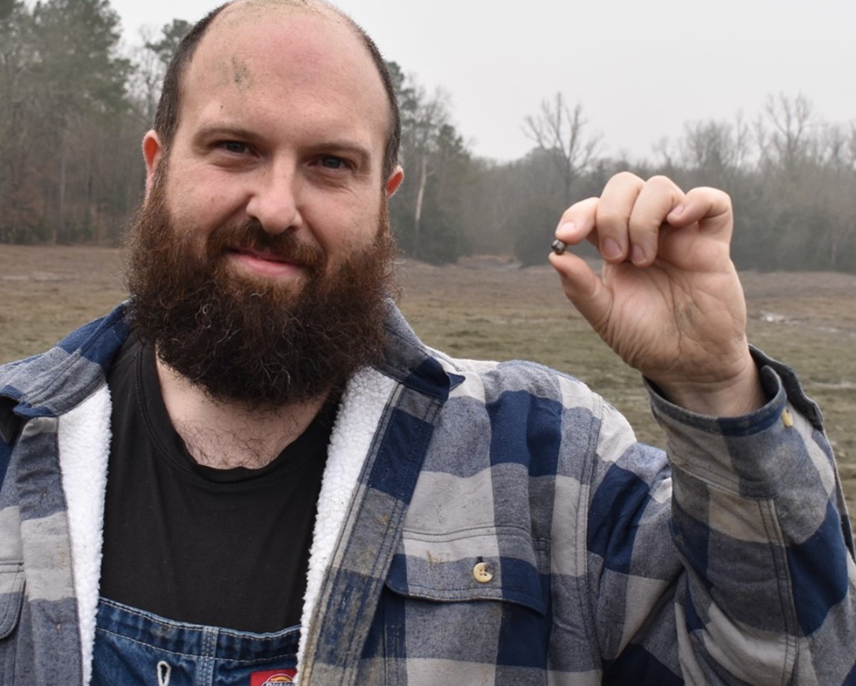 An image of Julien Navas with a brown diamond found at the Crater of Diamonds State Park
