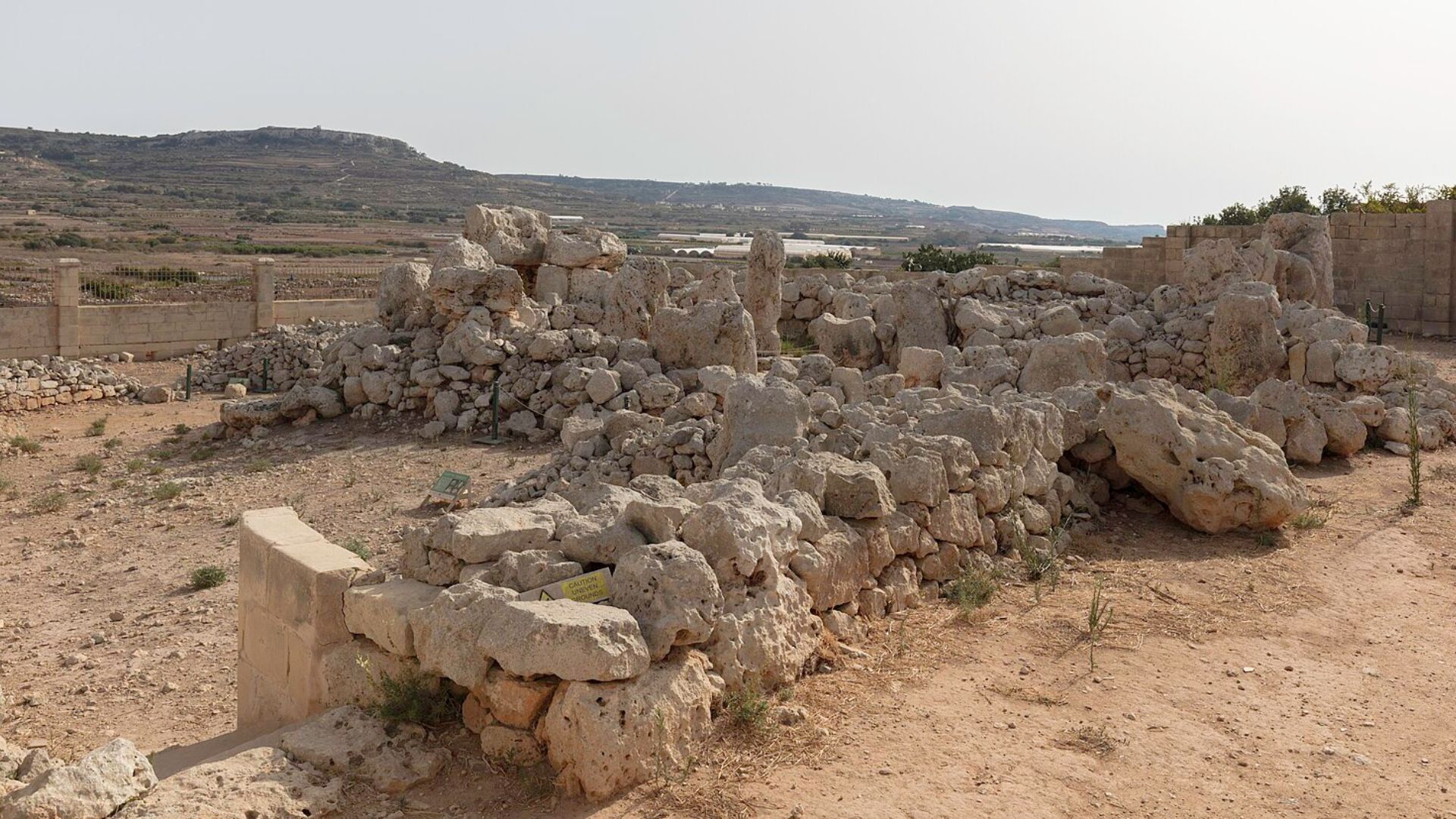 Photograph of a pile of large limestone boulders forming the ruins of an ancient megalithic structure in Malta