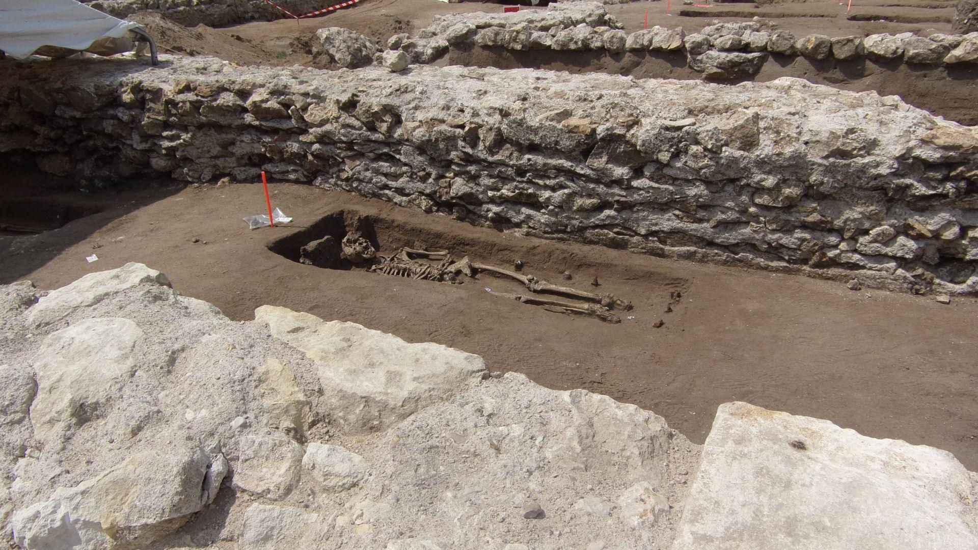 A view of a human skeleton and burial remains in the archeological dig of Beaumont Abbey in France.
