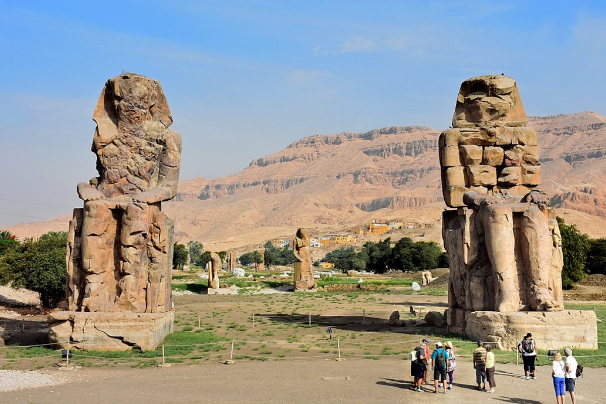 An image depicting the Colossi of Memnon of Egypt during a clear day