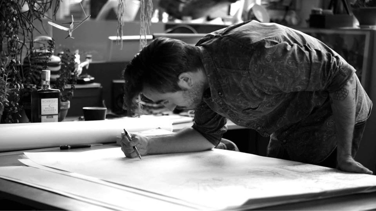 Famous illustrator Ugo Gattoni working in his studio