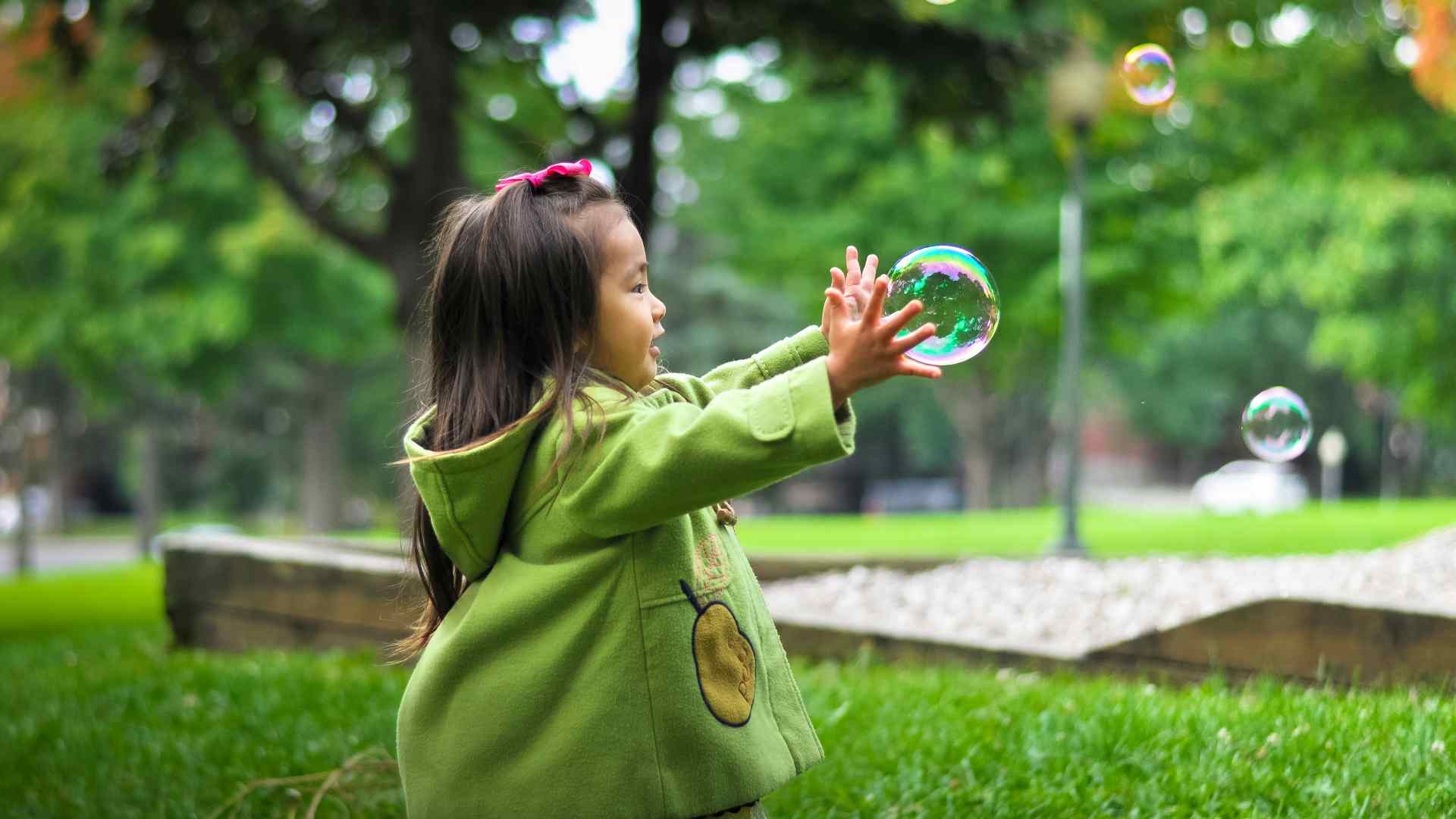 A girl playing with bubbls.
