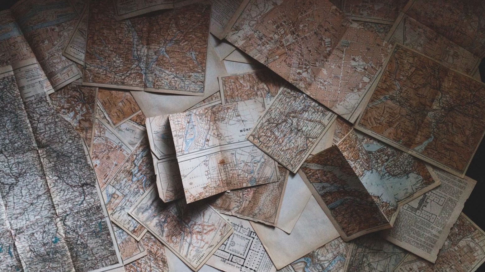 Various maps that look relatively old are scattered over the floor.