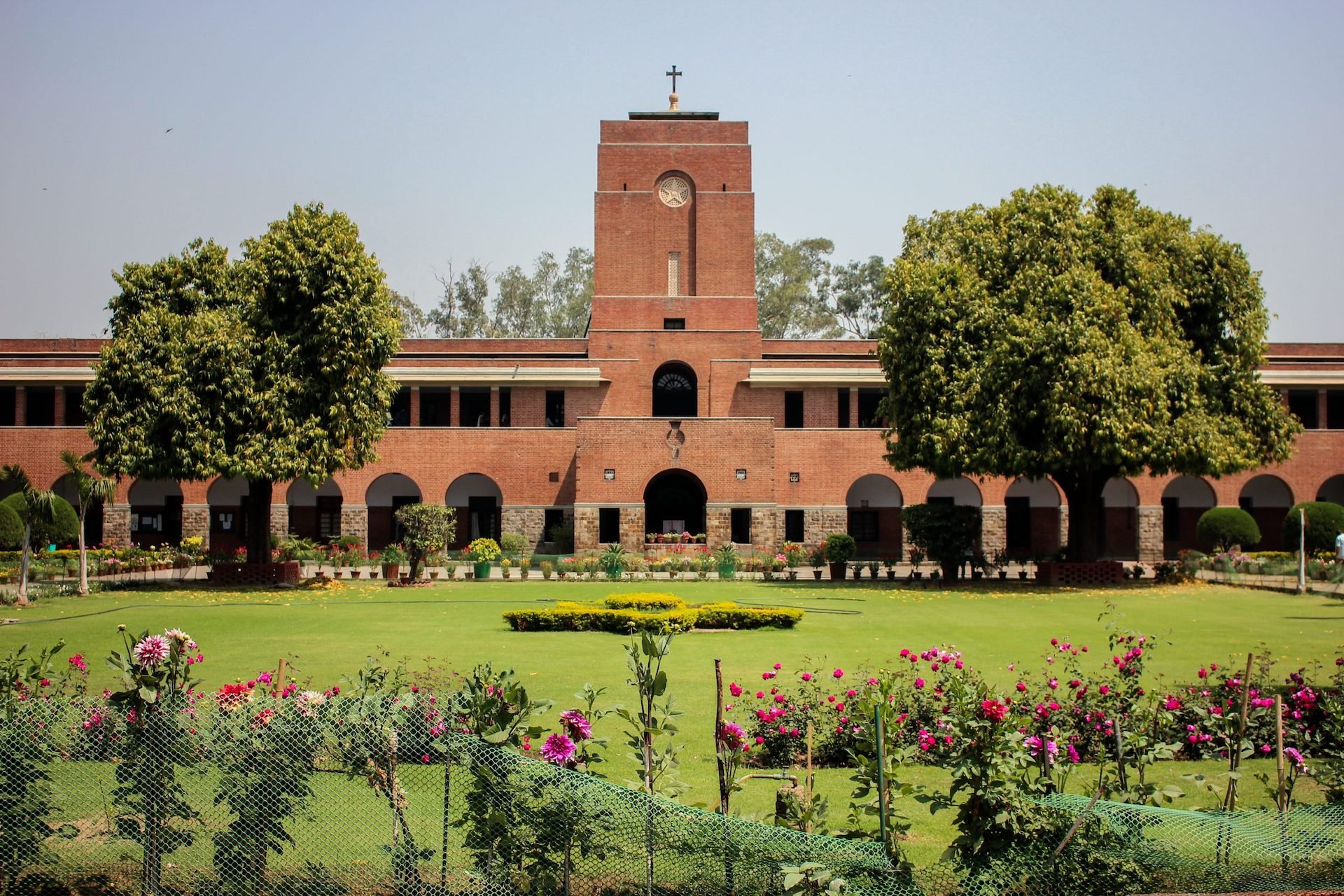 A wide shot of a brick building and a large open yard at the College of Saint Stephens