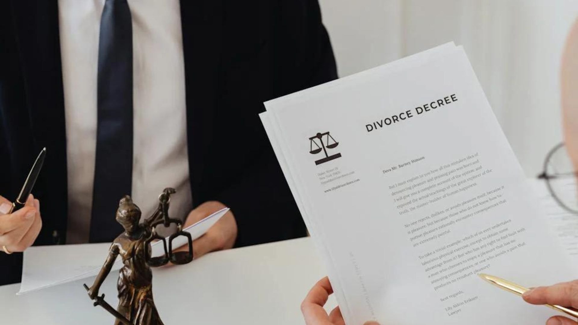 A person holding a set of papers. At the top of the paper it says "Divorce decree" in black, bold letters