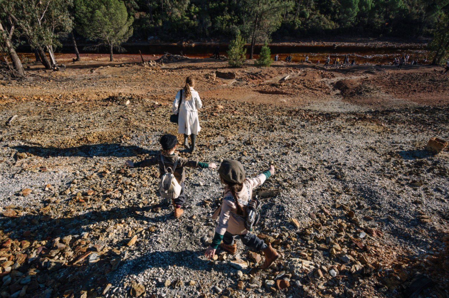 An image of a family walking in a muddy field