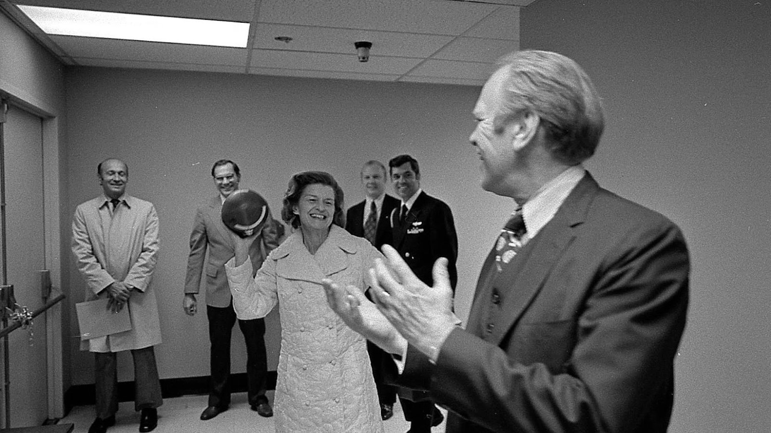 U.S. President Gerald Ford and his wife tossing around a football while among others.
