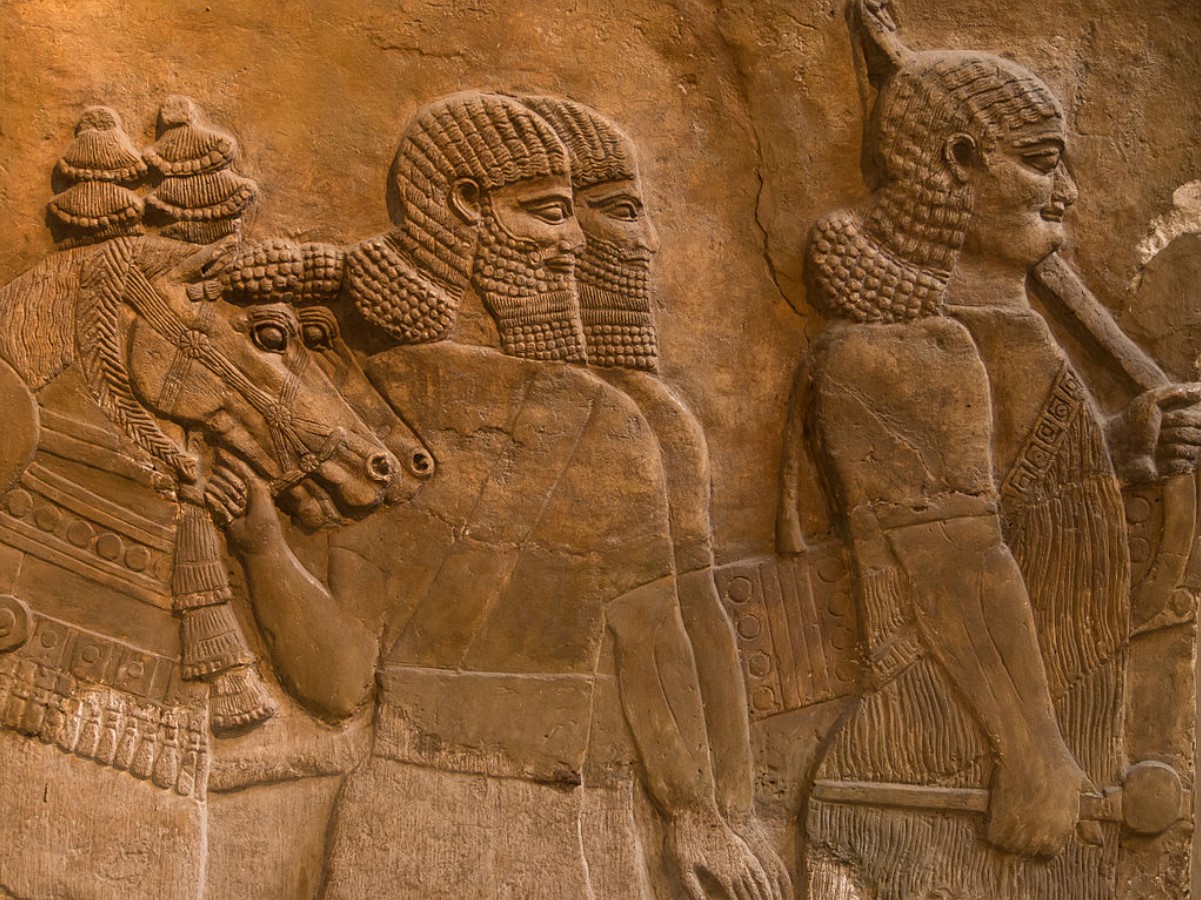 An image of several Assyrian traders with their horses