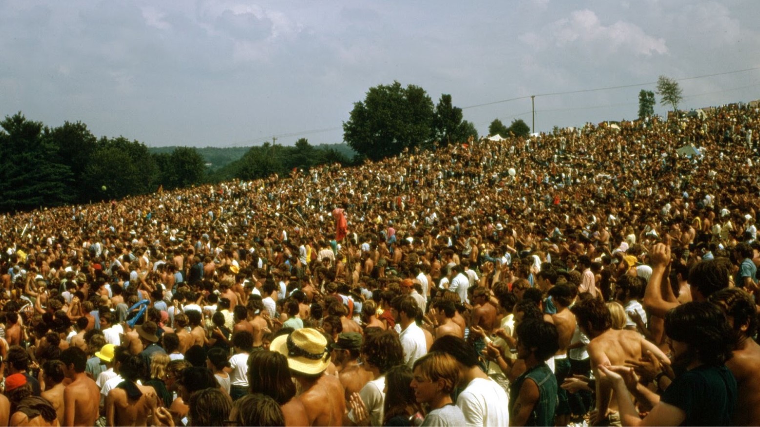 A huge crowd of people attending the Woodstock music festival in 1969.
