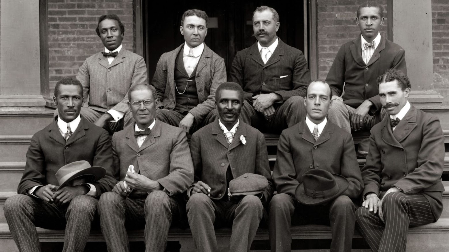 Many men, including George Washington Carver, posing for a photo in 1902.
