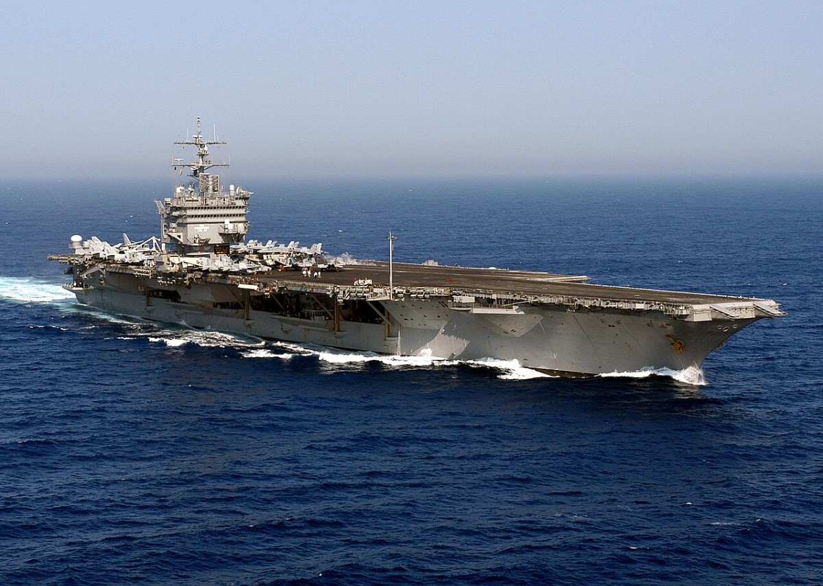 An image of a large US Navy aircraft carrier sailing the open sea