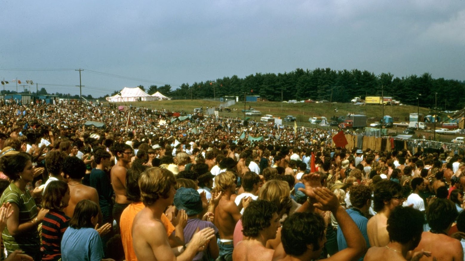 A huge crowd giving a standing ovation at Woodstock in 1969.