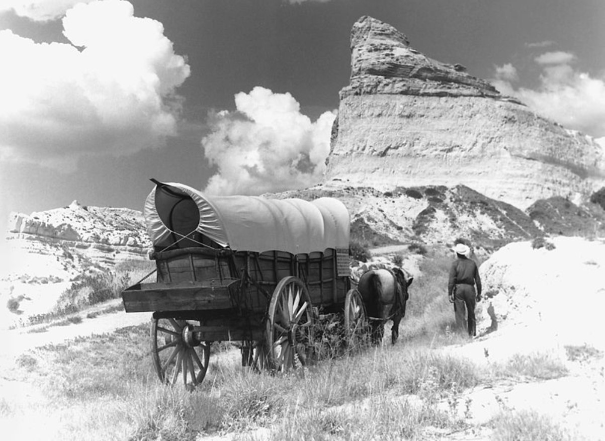 An image of a man and his cart on the Oregon Trail